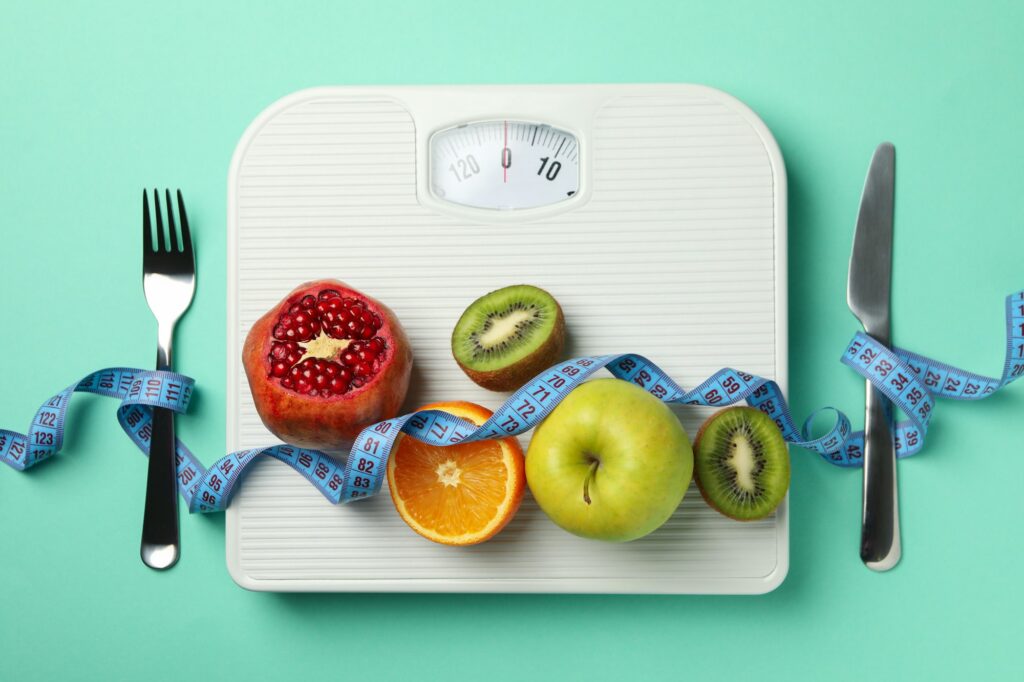 Weight loss or healthy lifestyle accessories on mint background